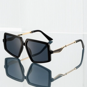 Oversized hexagonal sunglasses with thick black frames and gold metal temples