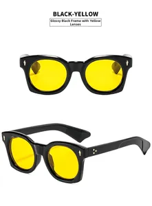 Détail de lunettes de soleil carrées noires avec verres jaunes et rivets dorés en étoile