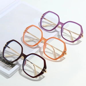 Three pairs of stylish oversized polygonal eyeglasses with metal temples on fashion magazines