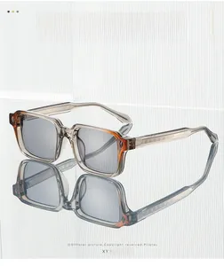 Detail showing translucent gray square frame with intricate metal engraved temples