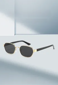 Close-up of hexagonal black lenses with gold metal frames and stylish black temples