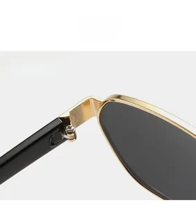 Detail of durable gold metal hinge on polygonal vintage sunglasses with black temples