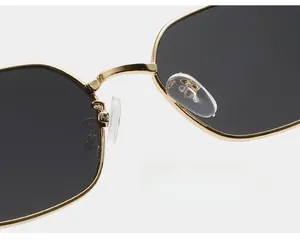 Detail of golden metal bridge and soft silicone nose pads on square sunglasses