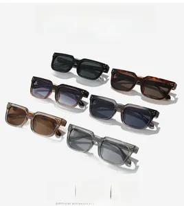 Détail de lunettes de soleil rectangulaires en acétate coloré avec rivets métalliques