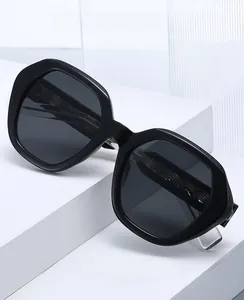 Detailed view of 2026 polygon black frame sunglasses on white geometric display stand