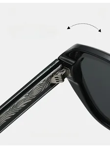 Macro shot of durable silver-textured metal hinge on stylish black polygonal sunglasses