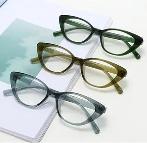 Detailed view of cat-eye eyewear frames in transparent green, amber, and grey-blue colors