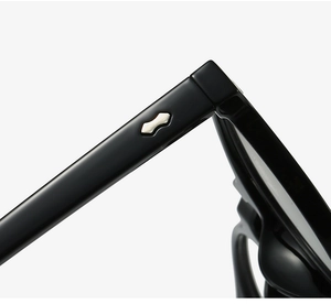 Detail of TR90 glasses frame showing polished black finish and silver dumbbell rivets