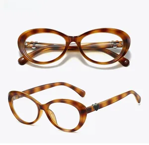 Detail of tortoise shell cat-eye glasses with heart metal hinge and polished finish