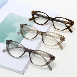 Retro cat-eye eyeglasses frames in tortoise, tea and grey finishes on magazine