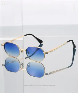 Detail of octagonal metal sunglasses with gradient blue lenses and gold frames
