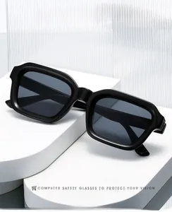Modern black square frame sunglasses displayed on a white geometric pedestal with textured glass