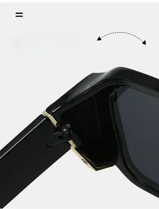 Détail de la charnière en métal doré sur lunettes de soleil rétro à double pont noir
