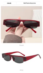 Detail view of stylish red semi-rimless sunglasses with gray lenses and metal hinges