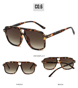 Detail view of leopard print sunglasses with gradient brown lenses and T-shaped metal hinges