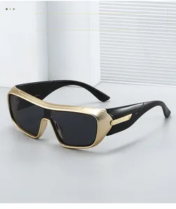 Detailed view of black and gold sports sunglasses with one-piece wrap lens and metal trim