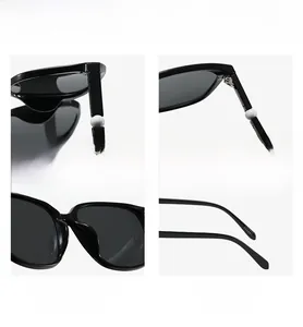 Details der mit Perlen verzierten Bügel und Metallscharniere der quadratischen Sonnenbrille