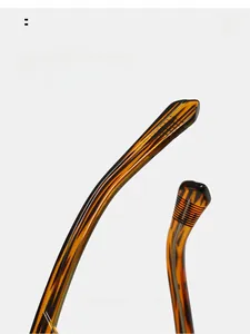 Macro shot of curved amber tortoiseshell temples for sunglasses with a smooth finish