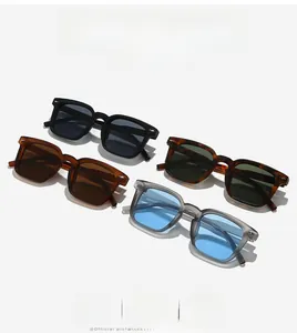 Close-up of square sunglasses in four stylish colors with thick frames and arrow rivets