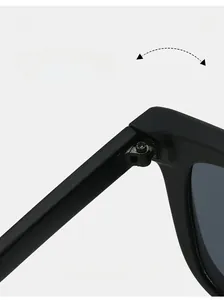 Detail view of durable metal hinge on matte black square sunglasses with arrow rivets