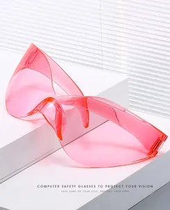 Detail view of pink rimless oversized Y2K wrap-around sunglasses with transparent lenses