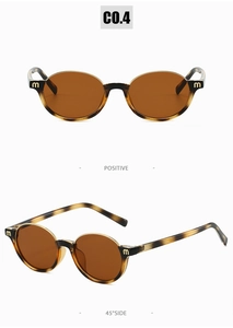 Vue détaillée de lunettes de soleil ovales en écaille avec logo m en métal sur charnière
