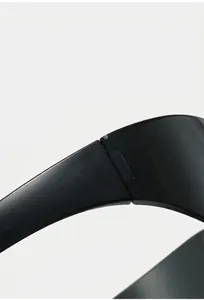 Macro view of durable metal hinges on lightweight black Y2K wraparound sunglasses
