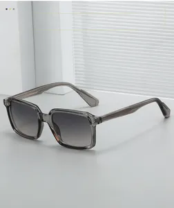 Detail view of square frame sunglasses with transparent grey finish and gradient lenses