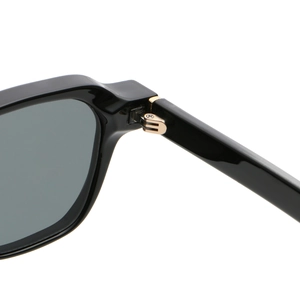 Macro detail of high-gloss black frame with premium golden metal hinges on sunglasses