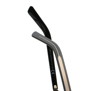 Detail view of black PC sunglasses arm with gold textured metal inlay and CE markings