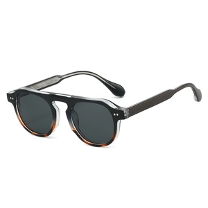 Lunettes de soleil rétro monture ronde dégradé noir ambre avec rivets argentés