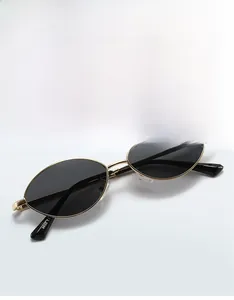 Detail shot of golden metal sunglasses frame with 9655 model number and CE certification