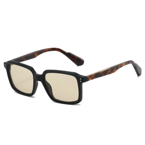 Black square sunglasses with amber lenses and tortoiseshell temples on white background