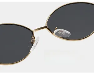 Detail shot of golden metal sunglasses with comfortable silicone nose pads for daily wear
