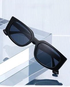 Detail of black square PC frame sunglasses showing temple specs on acrylic stand