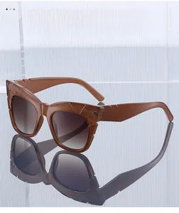 Detail of square sunglasses featuring thick textured temples and brown gradient lenses