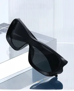 Detail of oversized 2026 sports sunglasses with dark grey one-piece wraparound lens