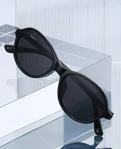 Macro detail of oval black frame glasses with anti-blue light lenses on acrylic blocks