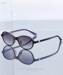 Detail of gradient purple lenses and metal ring buckle on oval fashion sunglasses