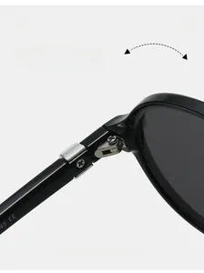Detail of durable metal hinge on black oval sunglasses with high-quality screw assembly