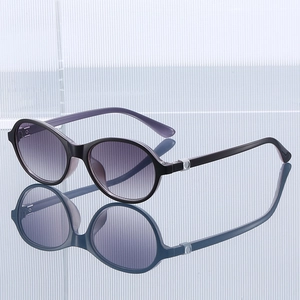 Oval black frame sunglasses with purple gradient lenses and clear light violet temples