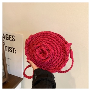 Detailed view of rose pink handmade crochet bag with 3D floral pattern and strap