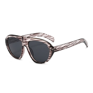 Fashionable oversized sunglasses with translucent brown tortoiseshell frame and dark grey lenses