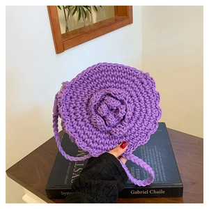 Detail of hand-woven purple crochet round bag with 3D rose flower and long strap