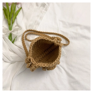 Detail of handmade woven shoulder bag in khaki cotton rope with a rustic knit texture