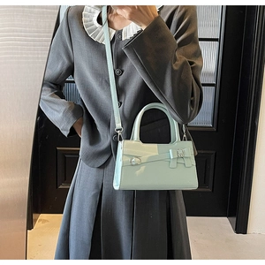 Detail of mint green matte tote bag featuring a bow accent and silver metal rings