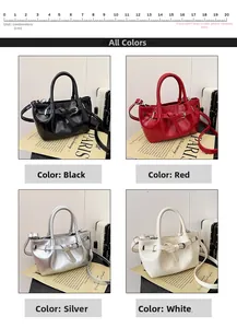 Detail of glossy patent leather handbags with decorative belt buckle and shoulder strap