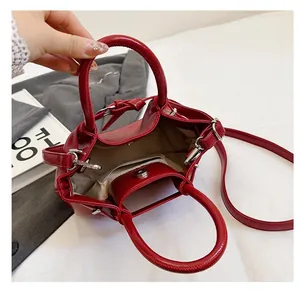 Detail view of red leather handbag interior showing magnetic buckle and inner pocket