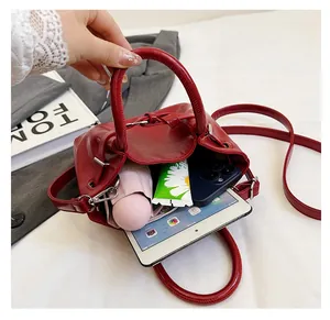 Macro view of red leather bucket bag interior showing capacity for tablet and phone