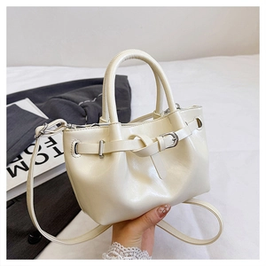 Detail of cream white mini crossbody bag with buckle decor and metallic hardware
